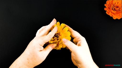 Fluffing the petals on the DIY paper marigold