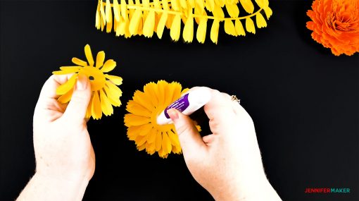 Gluing the base petals together of the DIY paper marigold