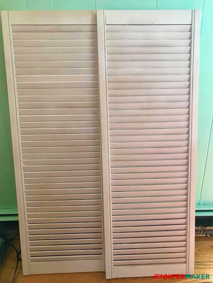 Old white shutters ready to be repurposed into a DIY paper organizer