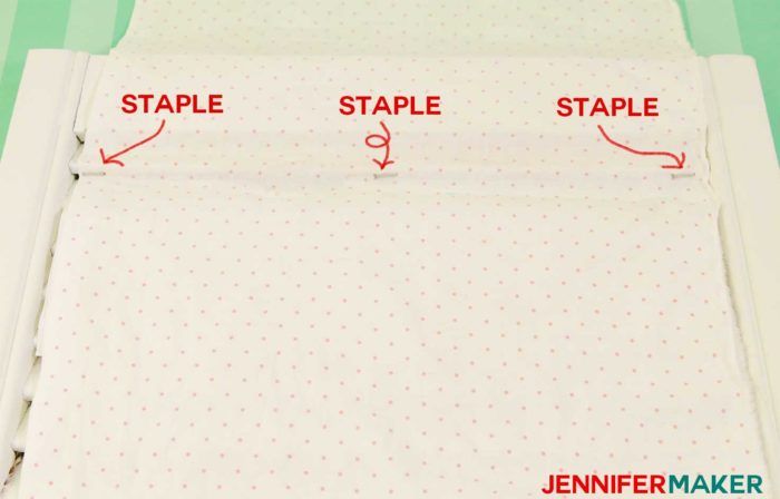 Staple the fabric to the bottom of the slat in three spots to make a DIY paper organizer