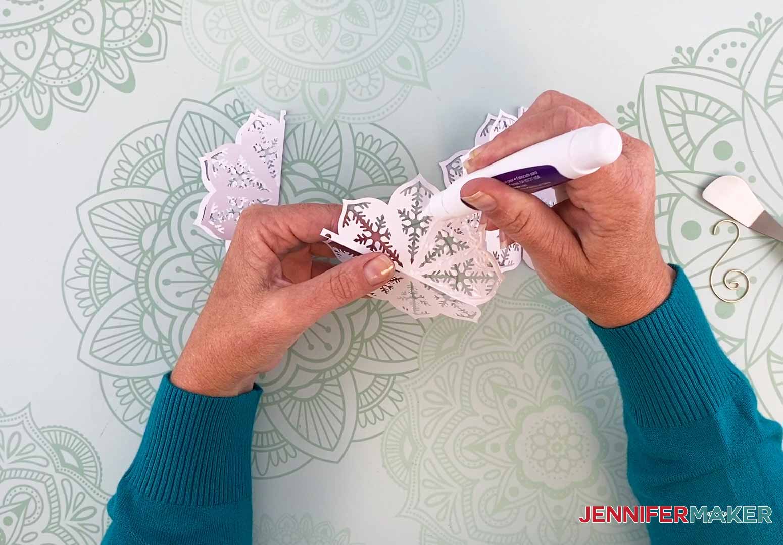 Add glue to one half of the diy paper ornament