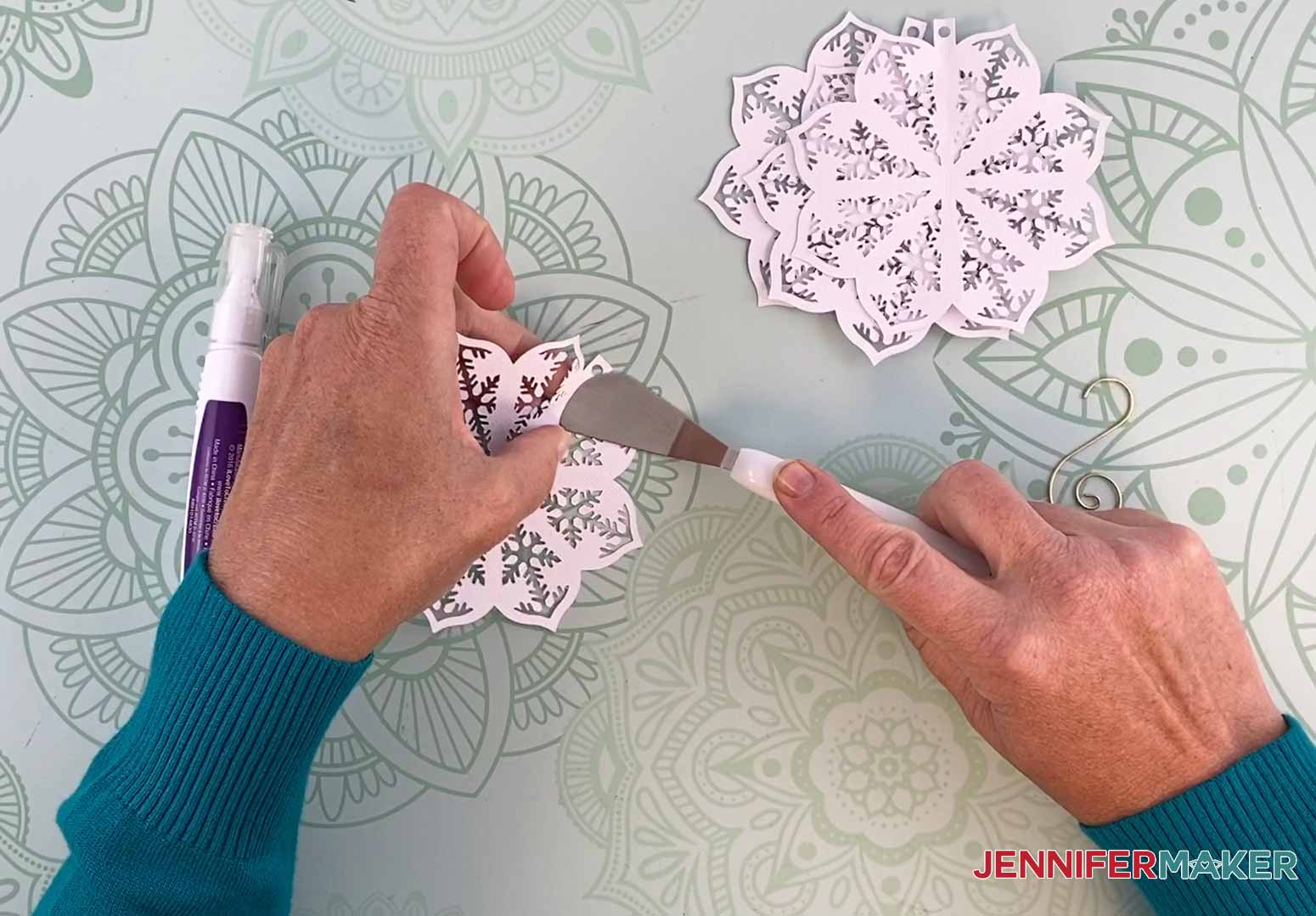 Use a Cricut spatula to help fold the score line for my diy paper ornament