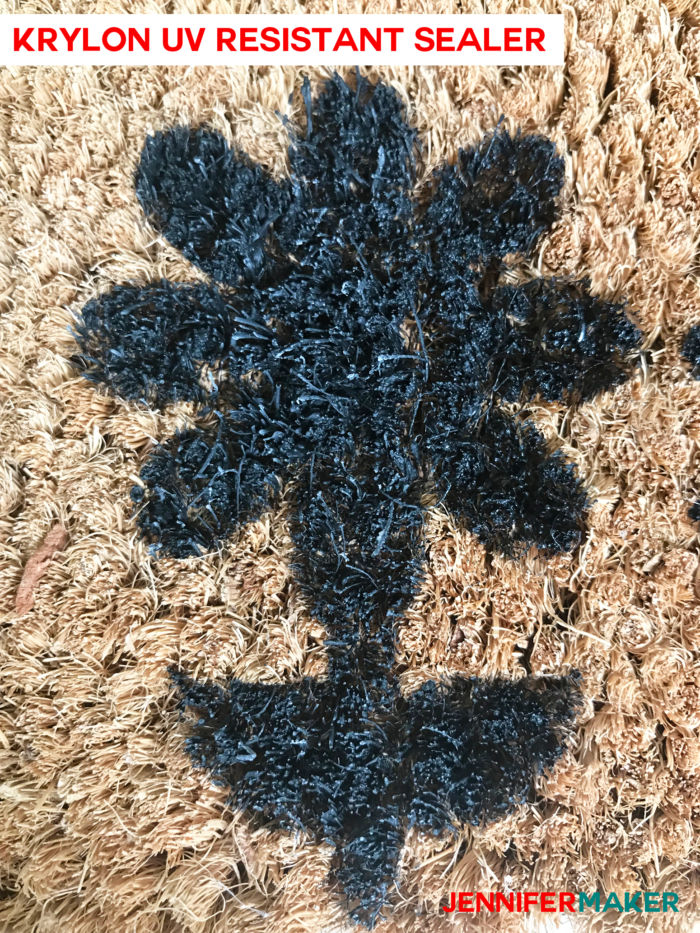 Close up of a DIY personalized door mat made of coir, painted with exterior house paint, and sealed with Krylon UV Resistant Clear Coating