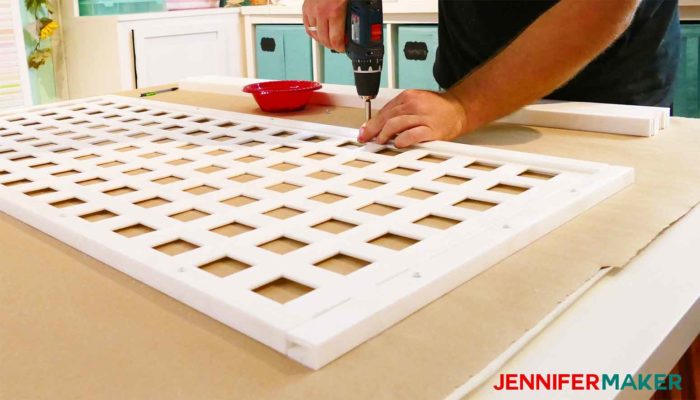 Screwing the lattice caps onto the lattice panels to make the DIY pet and baby gate