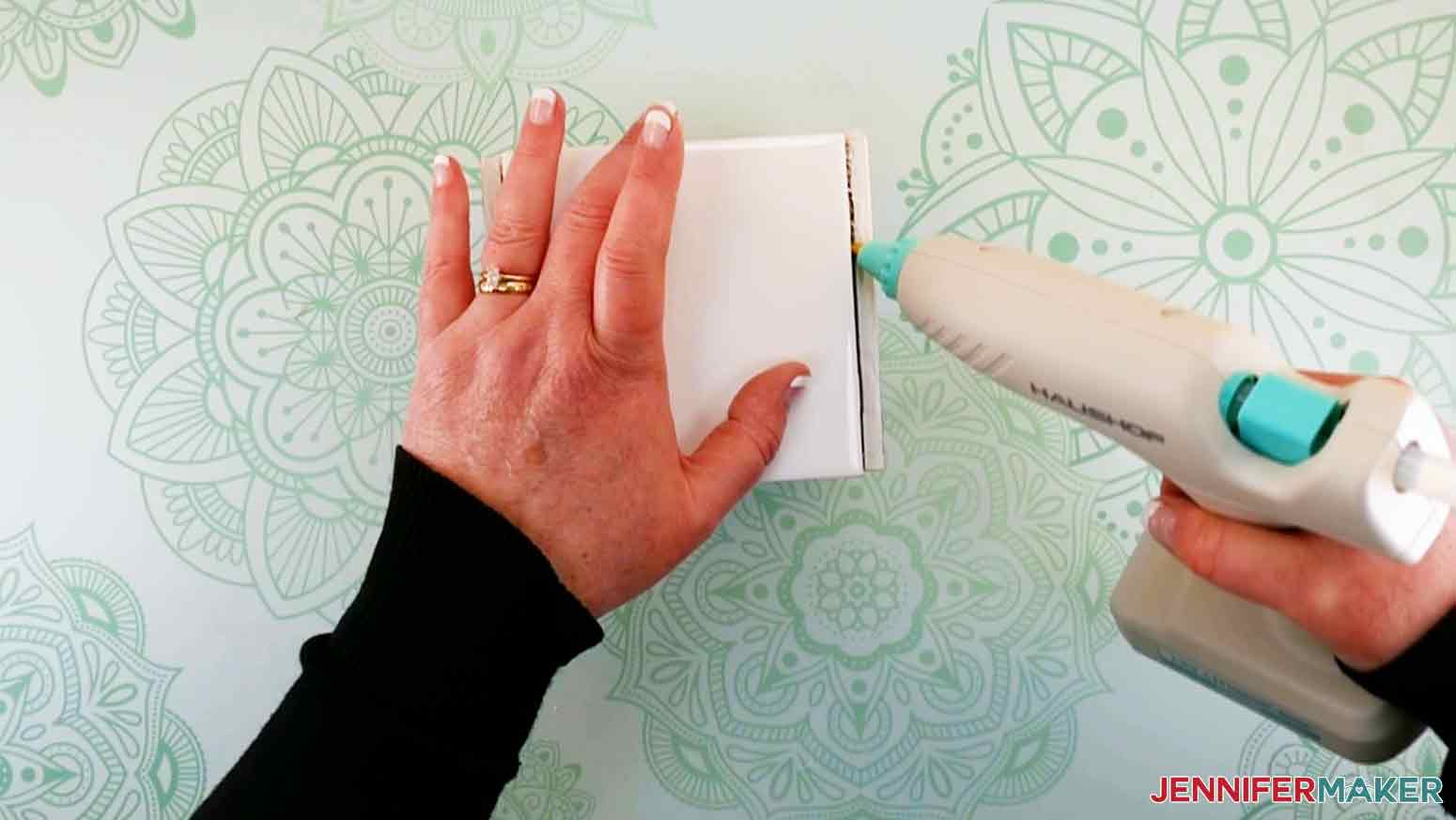 Use hot glue to seal any openings at the bottom of the planter for my DIY Plant Pot with Tiles project