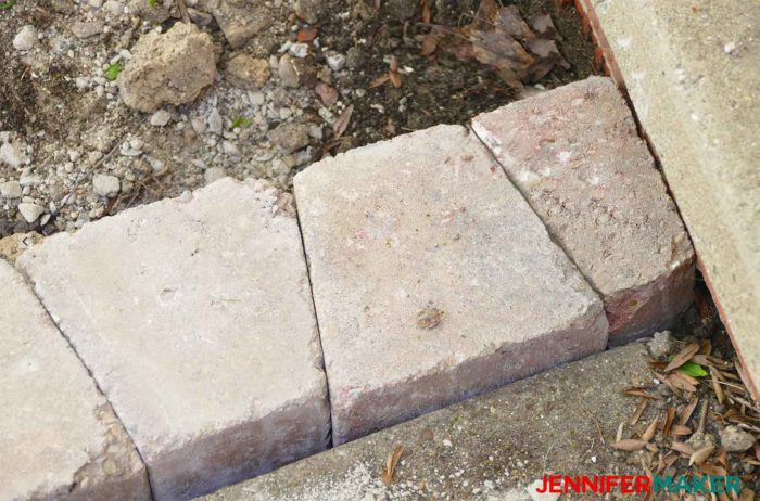 A retaining wall brick broken in half to fit into a tight spot