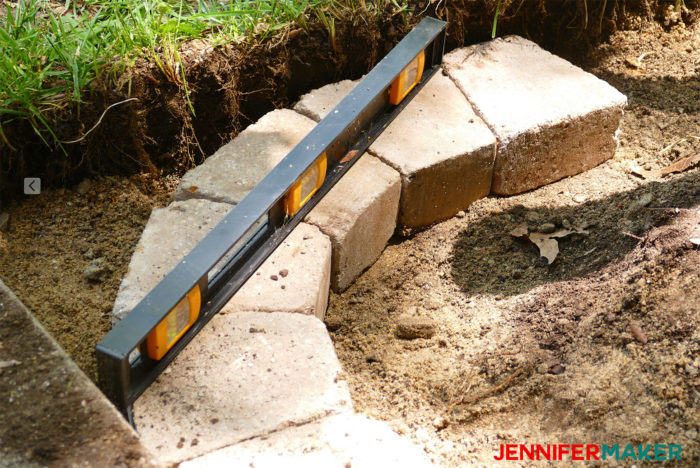 DIY retaining wall using wedge shaped bricks to make a neat curve