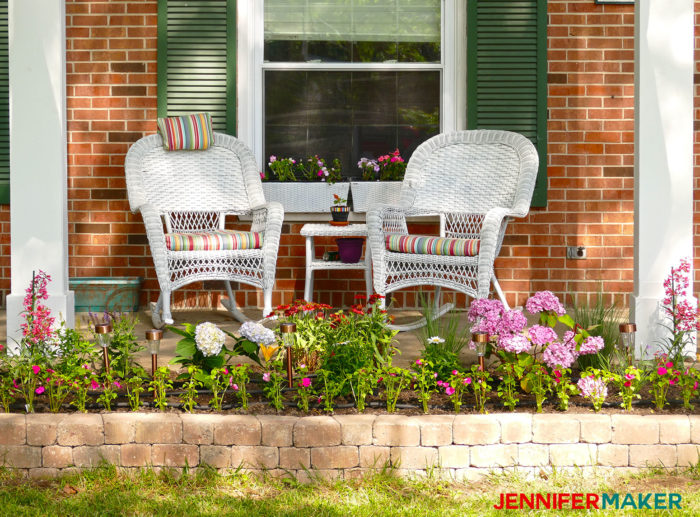 A garden DIY retaining wall in front of our brick house with white columns