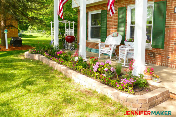 DIY retaining wall with a flower bed in front of our brick house