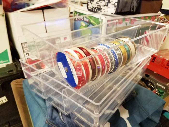 Craft ribbon stored in clear kitchen organizer trays