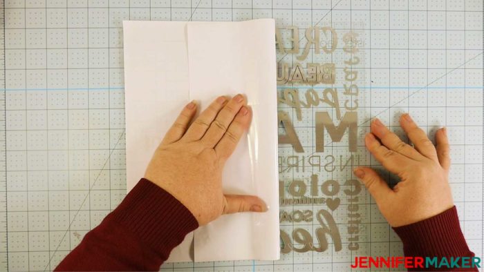 Peeling the backing off a layer of vinyl for the DIY subway art sign