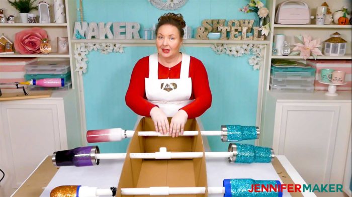  Jennifer rotating her epoxied tumblers on the homemade DIY tumbler turner made from a cardboard box