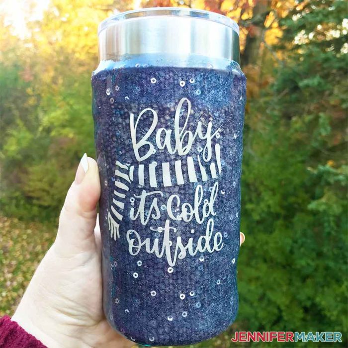 DIY Vinyl Decal of "Baby It's Cold Outside" on a purple sweater tumbler