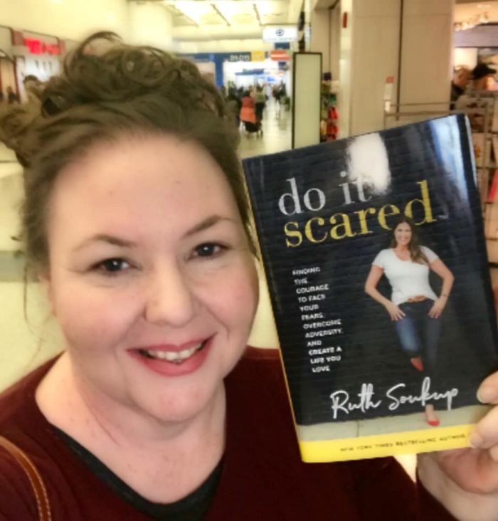 Jennifer Maker with her copy of Do It Scared in the airport on her way to New York City