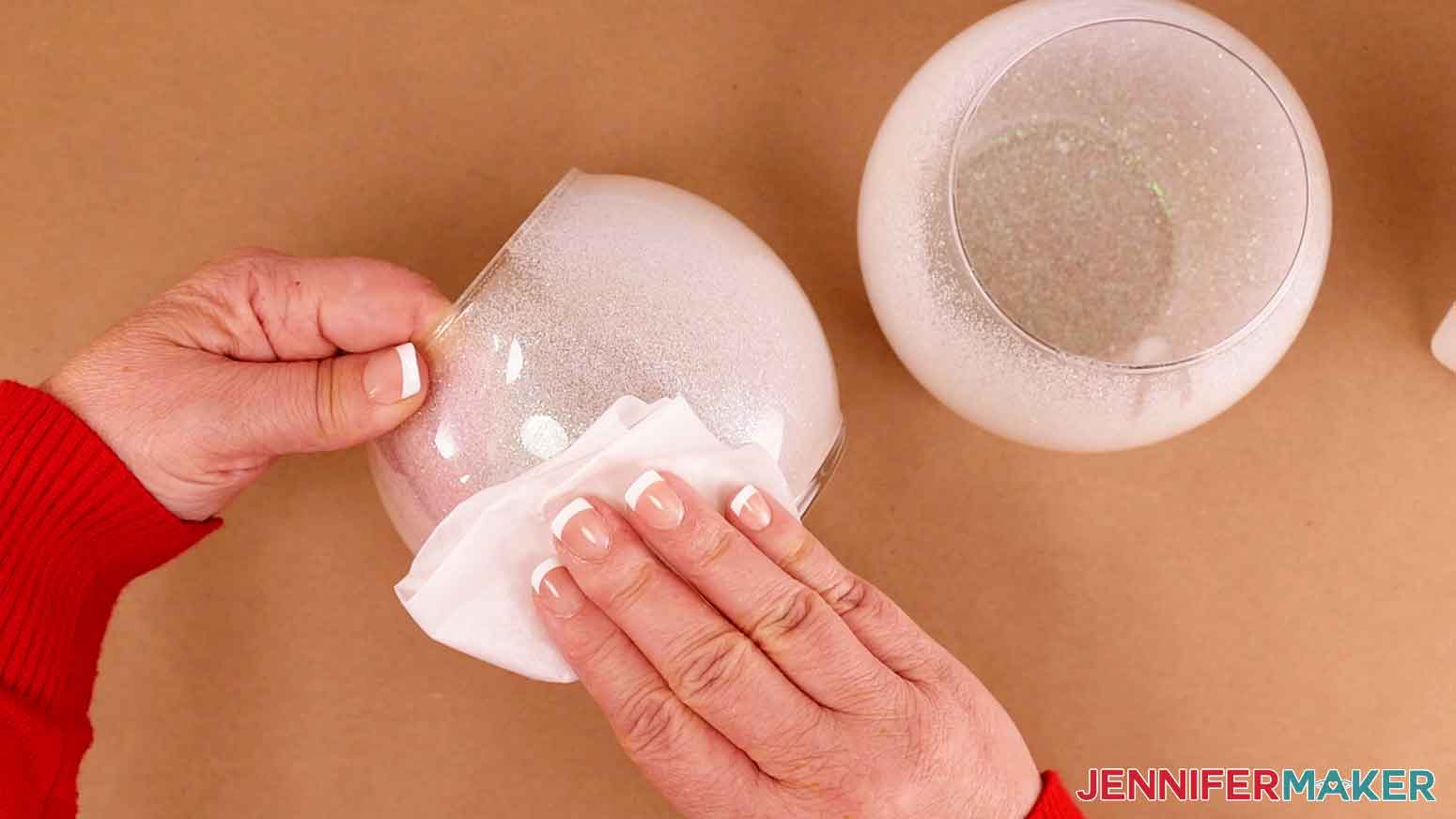 Use rubbing alcohol and a lint free cloth to clean the outside of the glass vase.