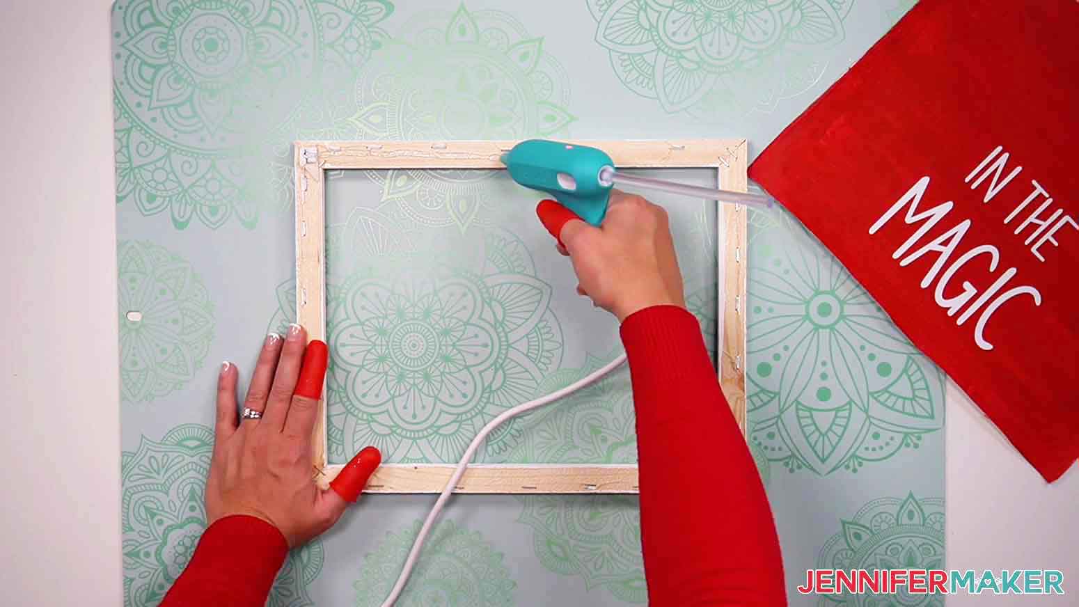 Use a hot glue gun to apply hot glue along the top of the canvas frame