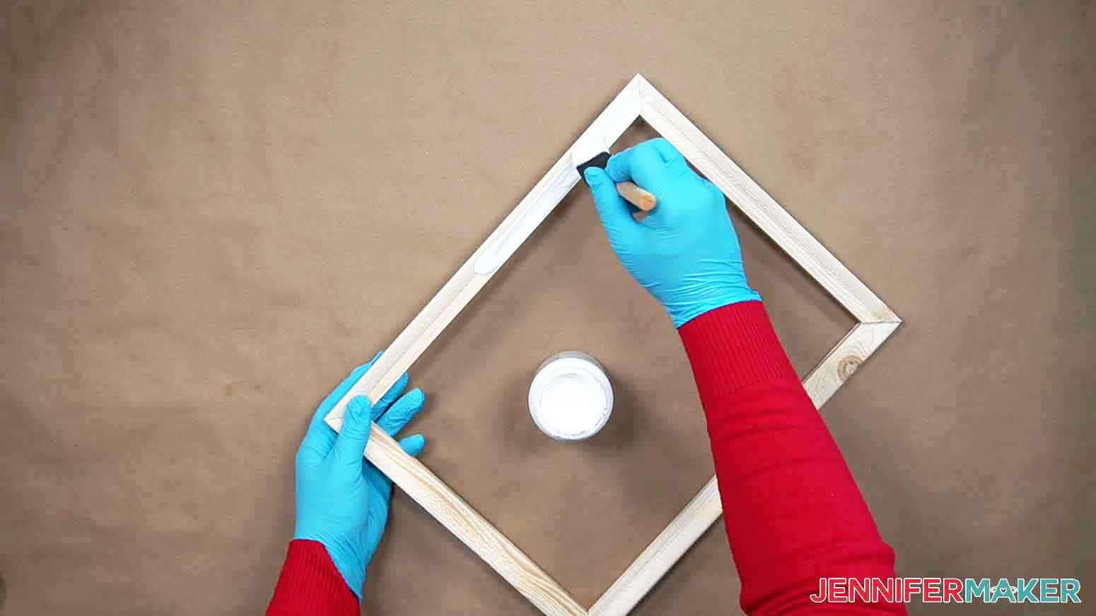Paint the canvas frame with white chalk paint using a foam paint brush.