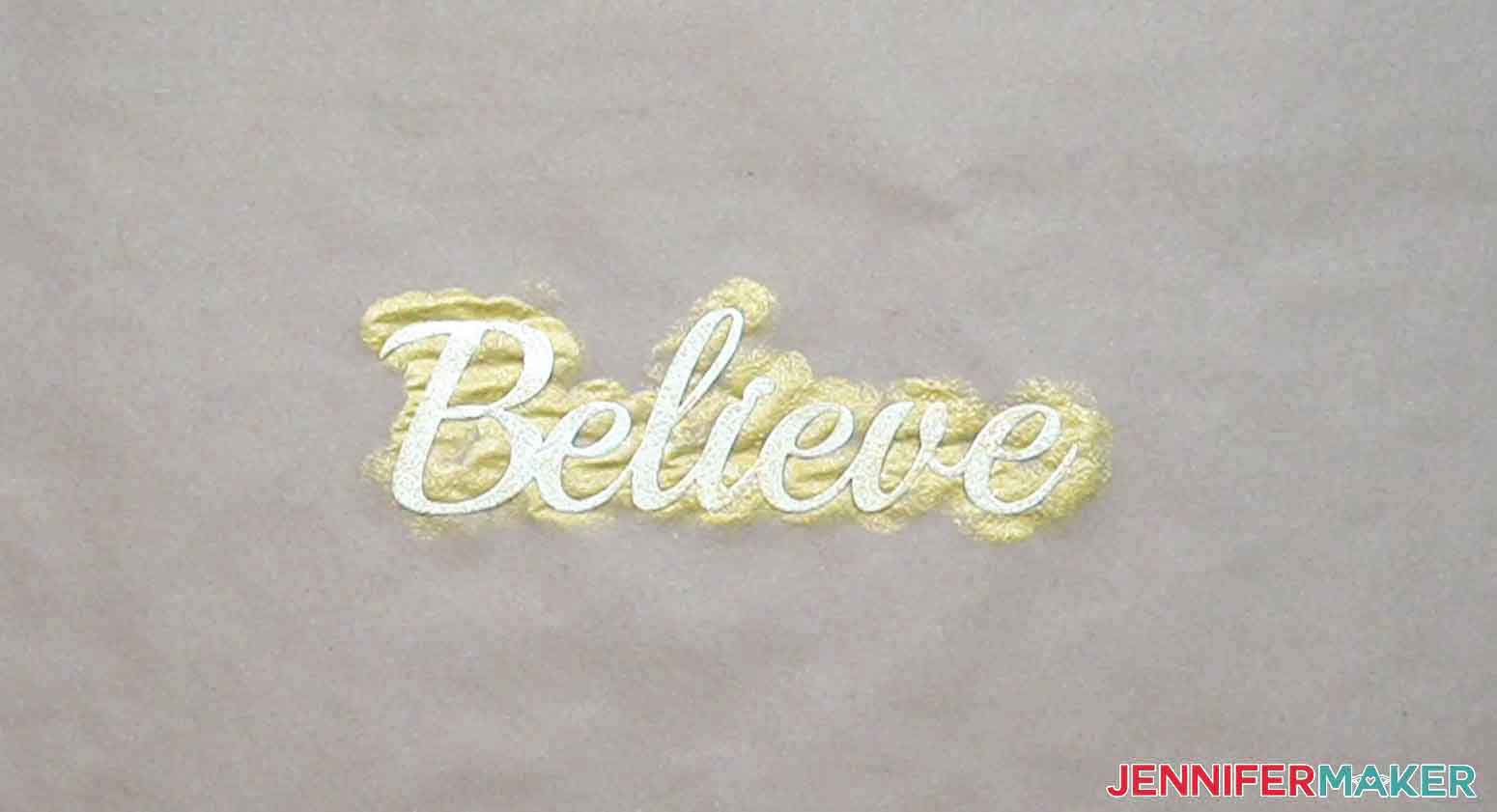 Believe metal word painted gold with a hammered look.