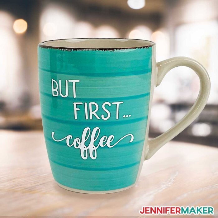 Turquoise mug from Dollar Tree with white vinyl that reads, "But First Coffee"