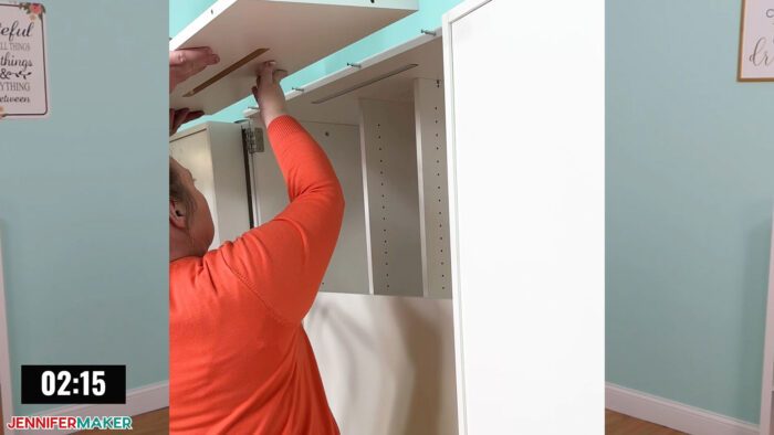 Jennifer Maker installing the crown light assembly on a DreamBox 2 craft storage solution.