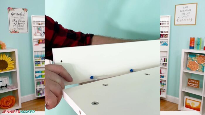 Greg Reese installing the side supports for a DreamBox 2 craft storage solution's crown light using locking hardware.