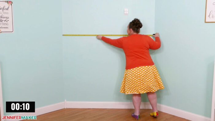 Jennifer Maker measuring wall space for DreamBox 2 craft storage installation.