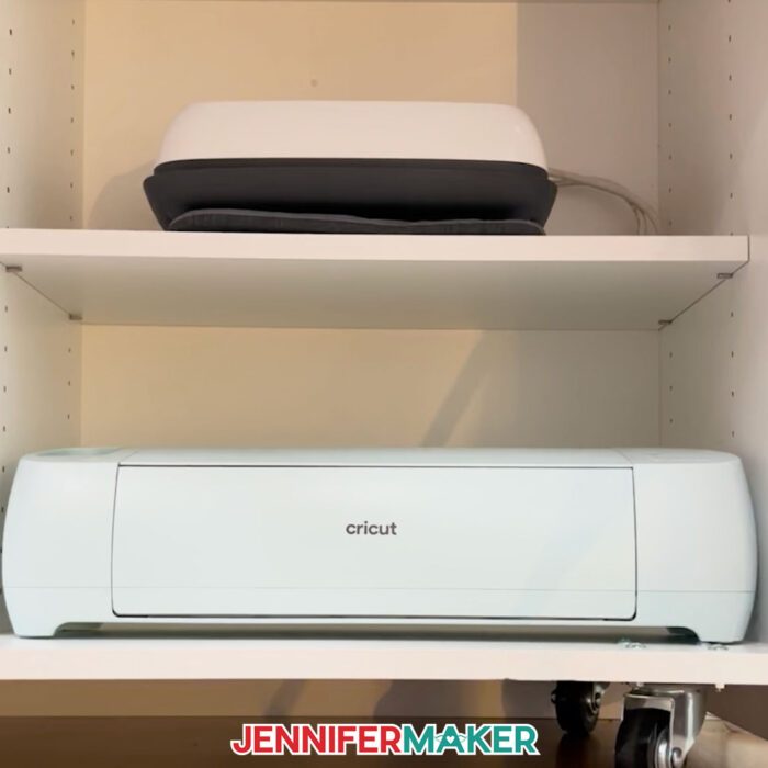 An EasyPress and a Cricut machine sit on the bottom shelves of a Dreambox Center.