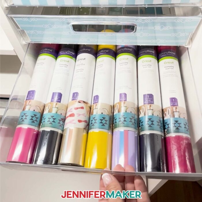 Rolls of Cricut Vinyl in a plastic storage tote.