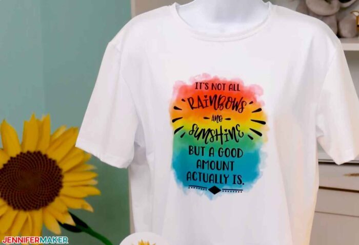 Dye sublimation shirt with a rainbow and the words "It's not all rainbows and sunshine but a good amount of it actually is"