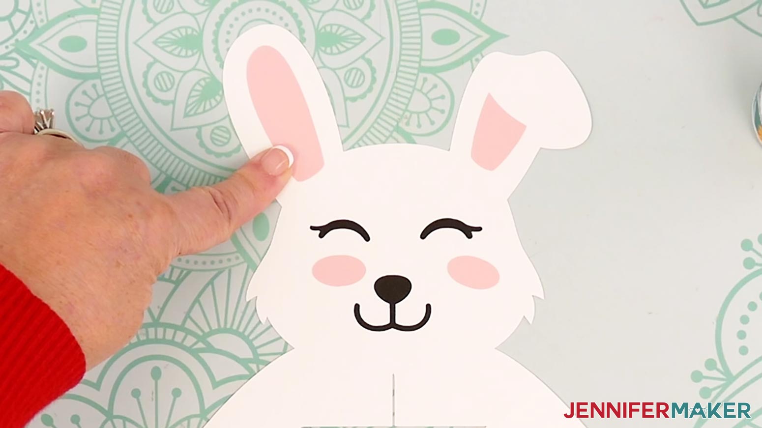 Glue the left ear piece to the center of the bunny lantern frame's left ear so the curves line up with the curves of the ear.