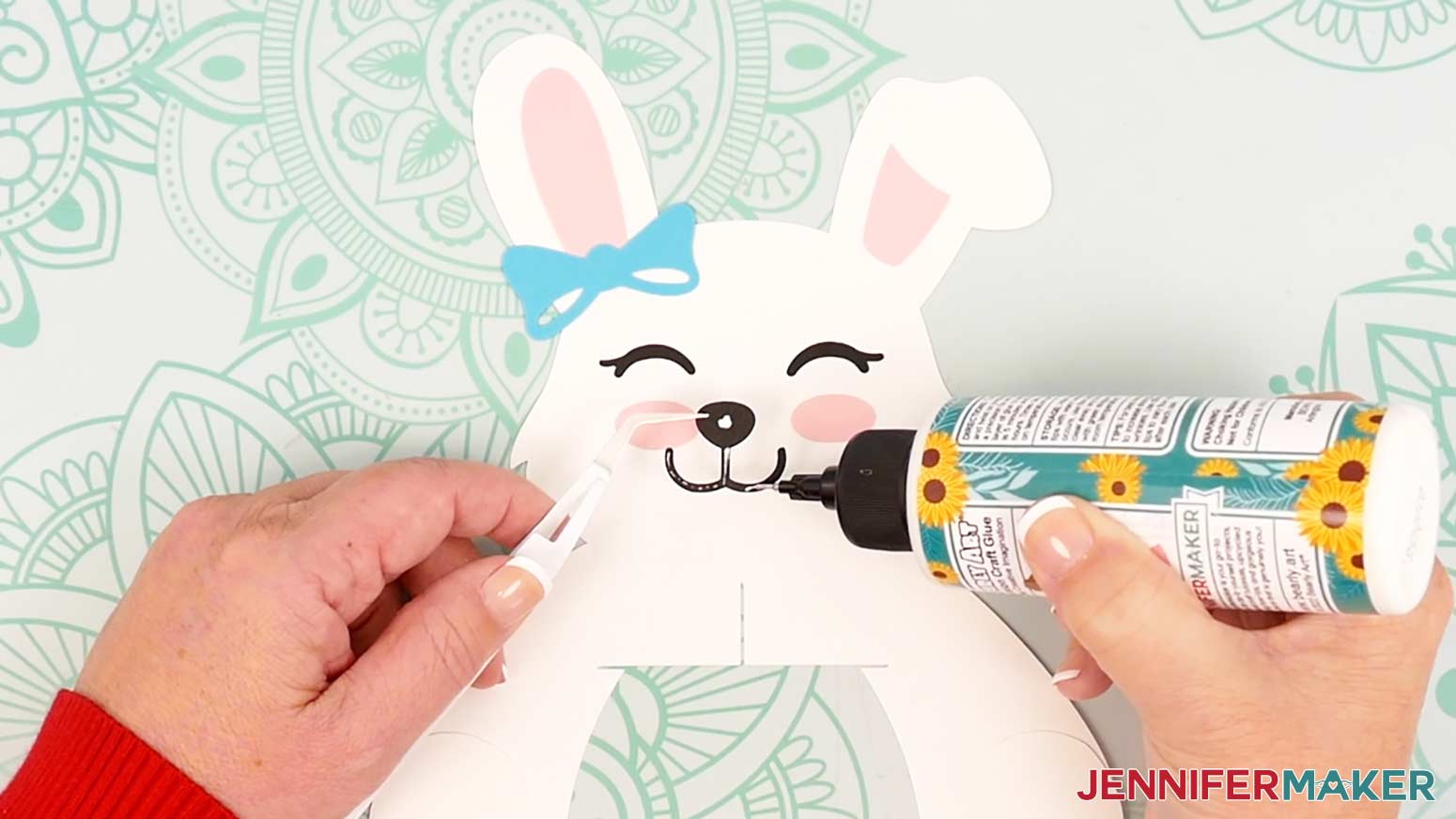 Add thin lines and dots of glue to back of the nose and mouth piece for the bunny lantern.