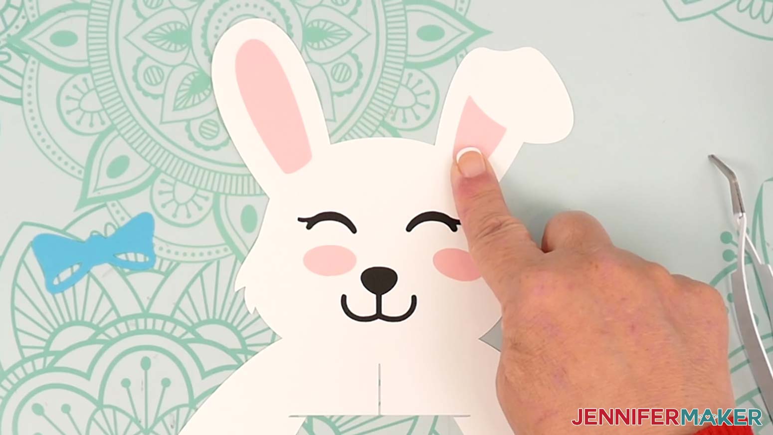 Glue the right ear piece to the bunny lantern's right ear, aligning the top curve with the curve of the flopped over ear.