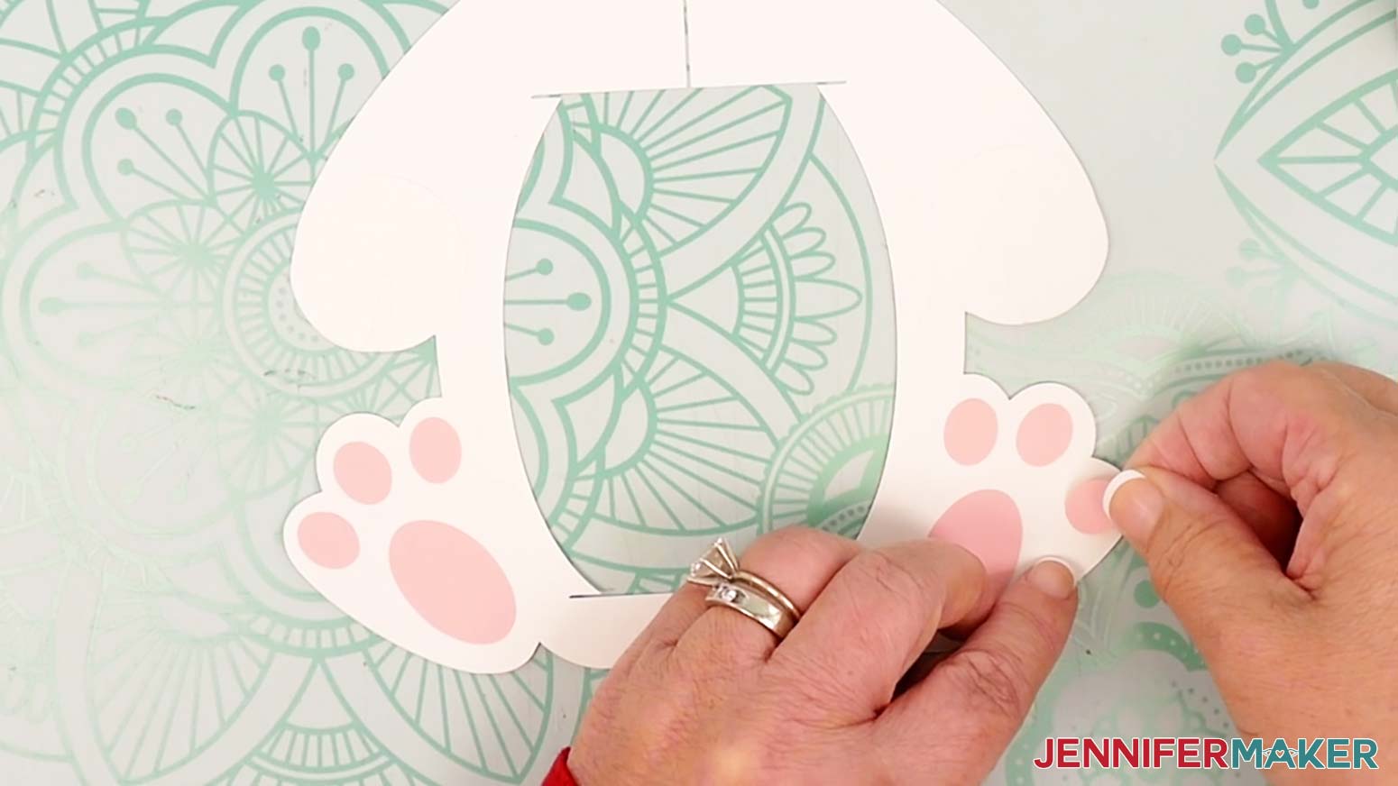 Adhere the six small toe pieces to the bunny lantern's feet, aligning their curves with the curves on the body frame.