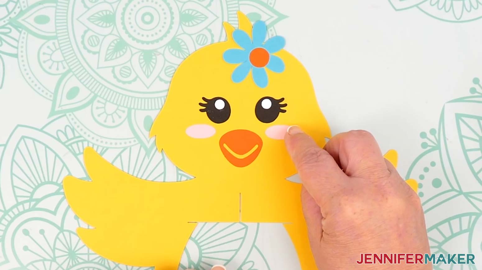 Adhere the oval cheek pieces to the chick lantern's face, one on each side of the beak.