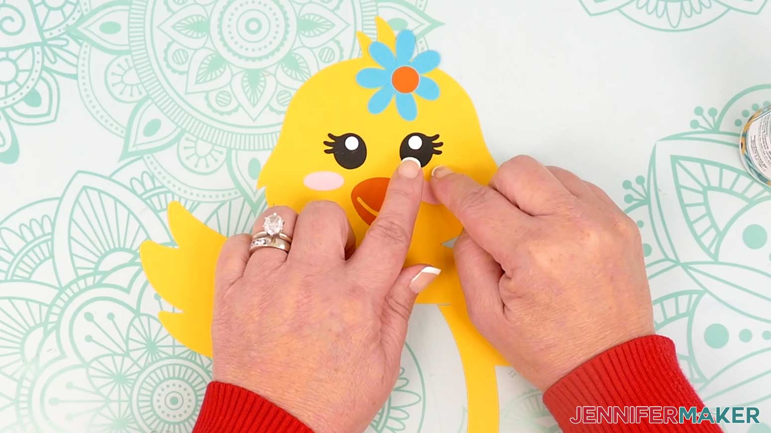 Adhere the right eye to the chick lantern's face with the eyelashes pointing to the right.