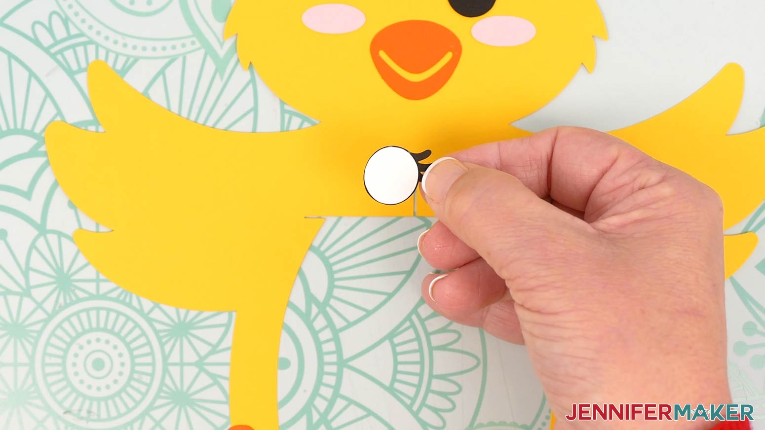 Glue the white eye piece to the back of the black eye piece for the chick lantern.
