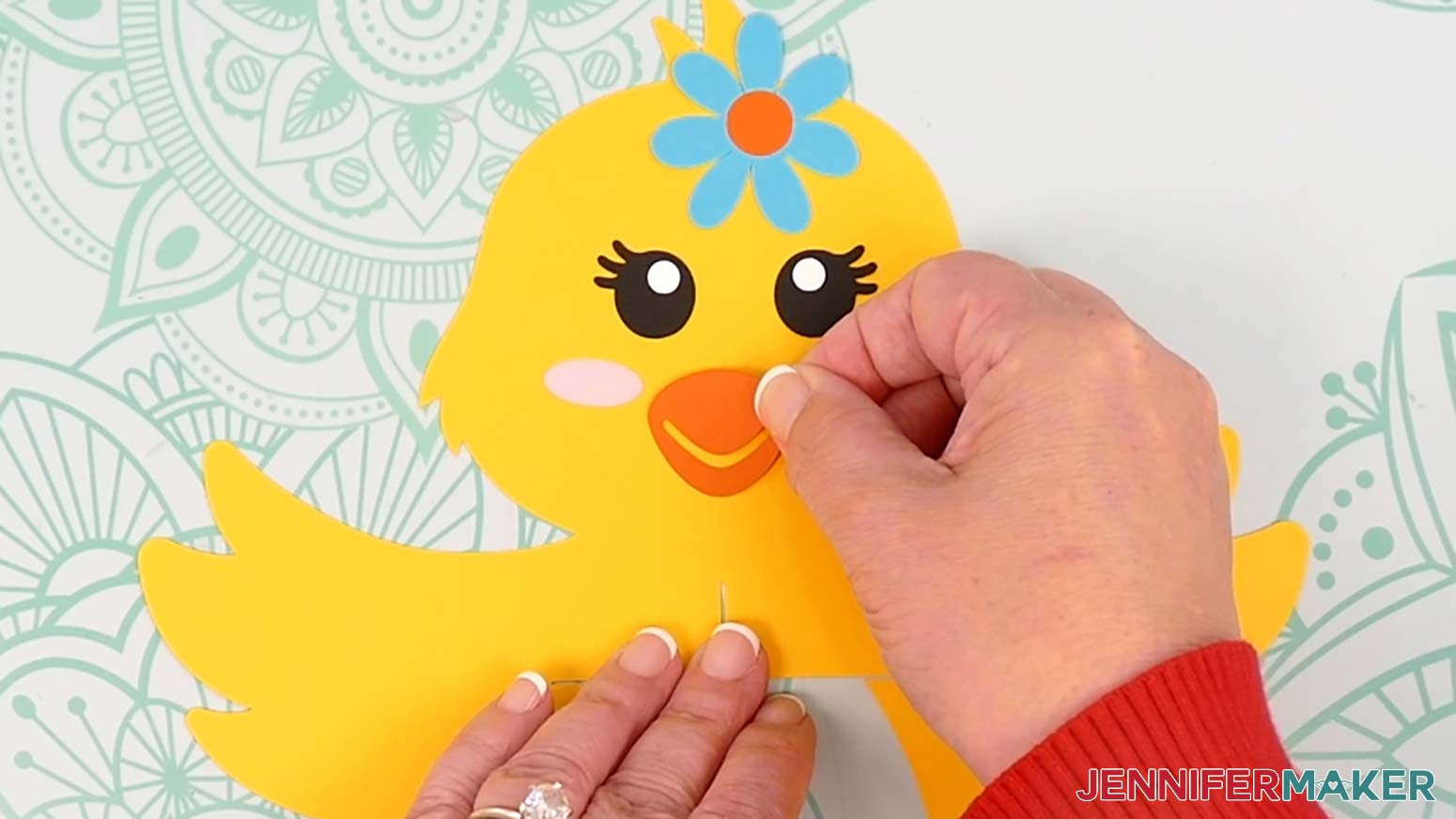Place the chick lantern's beak in the center of the face area so it's about a half inch above the neck and aligned with the slit.