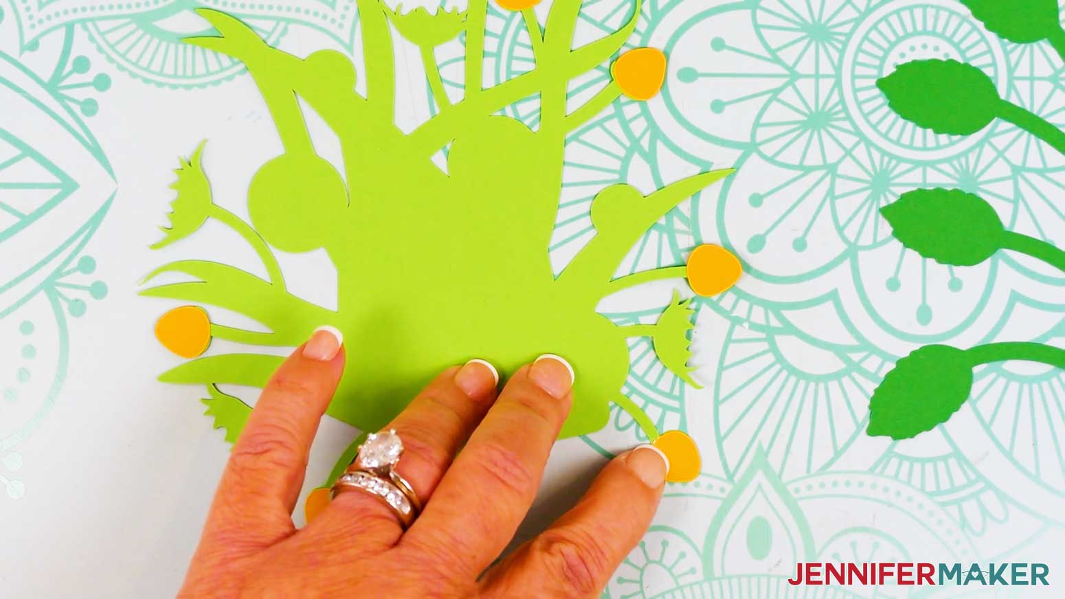 The buds have all been glued to the back of the light green foliage piece of the bouquet card.