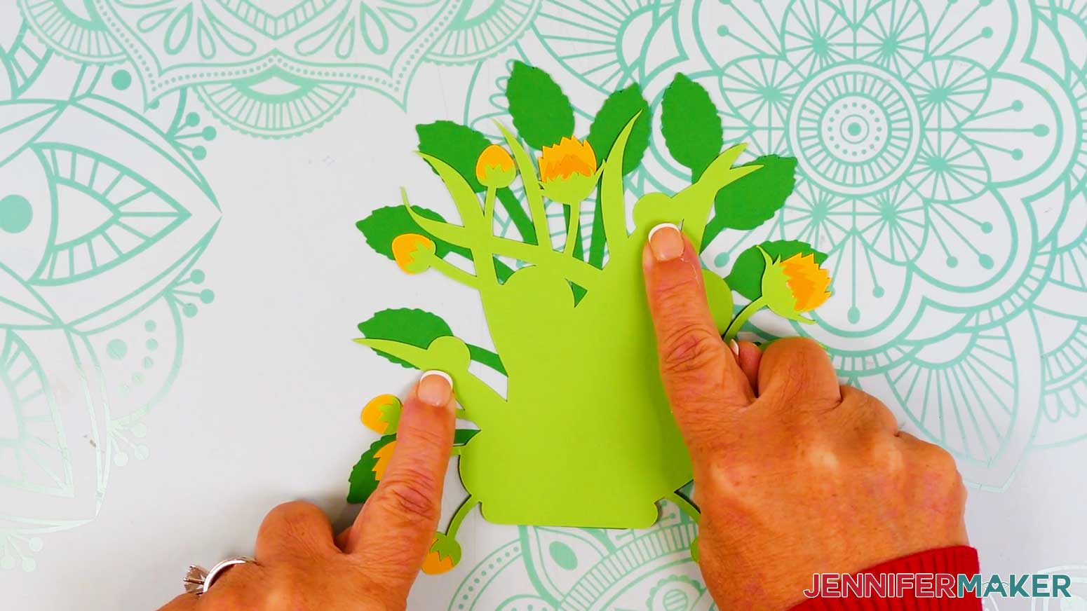 The foliage is shown face up and the fingers point to the half circle areas used for the placement of the sideways sunflowers.
