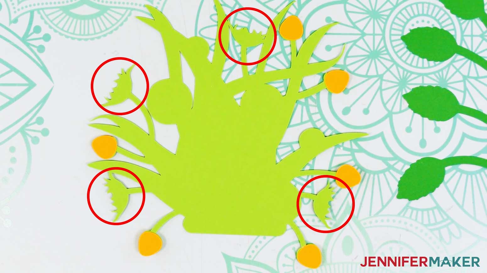 The light green foliage piece is shown face up on the table and the large sepals are circled to show the locations.