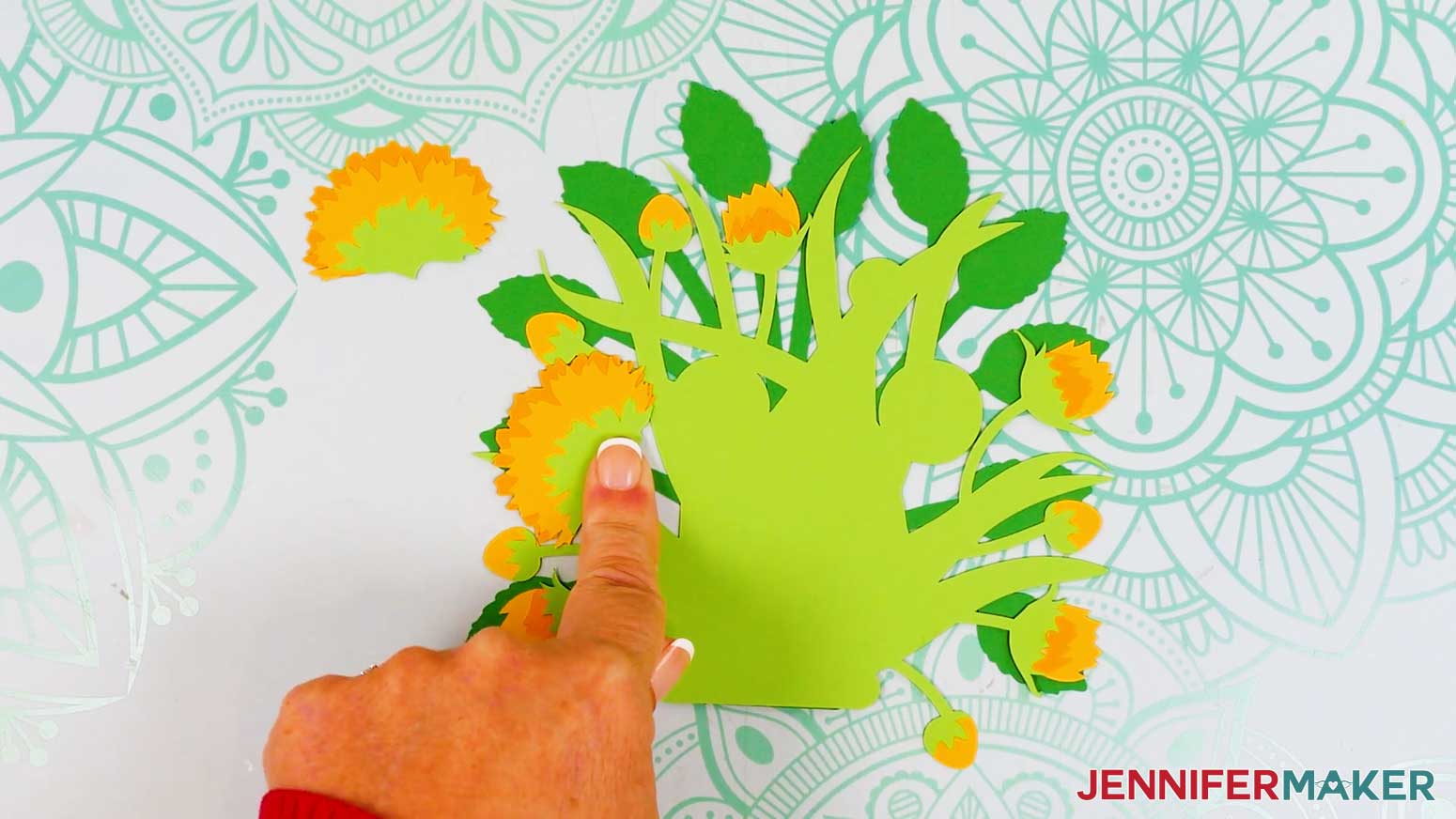 The sideways sunflower has been attached to the front of the light green foliage piece where the half circle was.