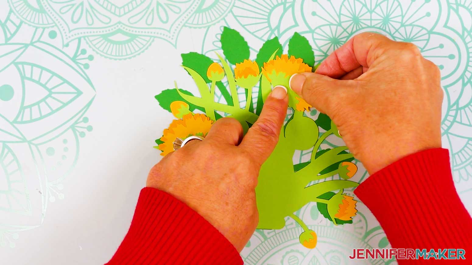The second sideways sunflower is being attached to the front of the light green foliage area where the half circle was.
