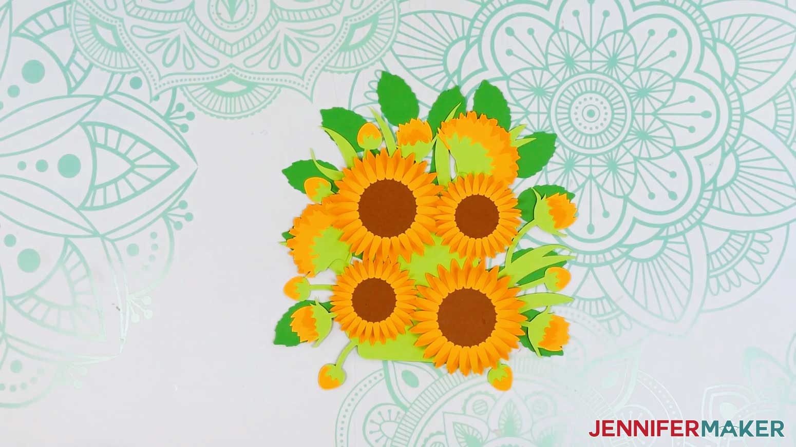 The large and small sunflowers have been attached to the face up side of the foliage layers.