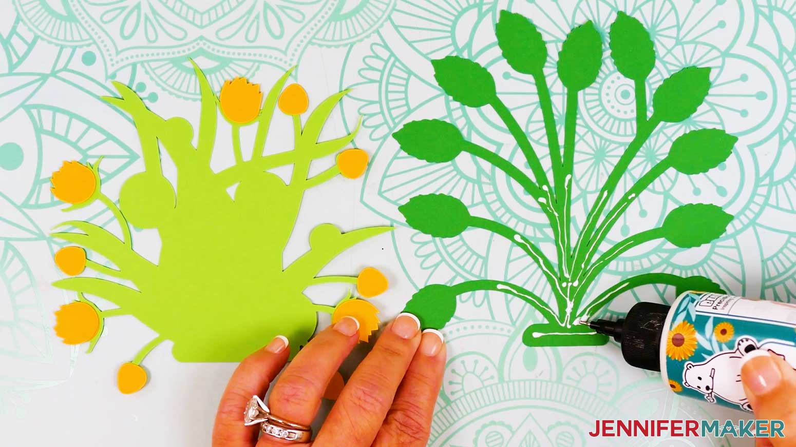 The light green foliage is backside up and glue has been applied to the front of the dark green foliage piece.
