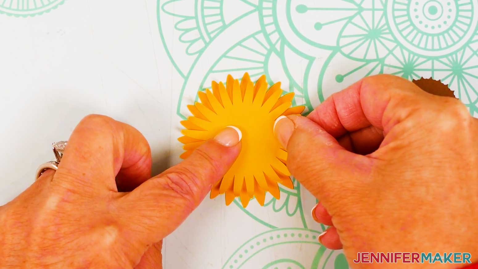 The yellow top petals are being glue to the top of orange bottom petals.