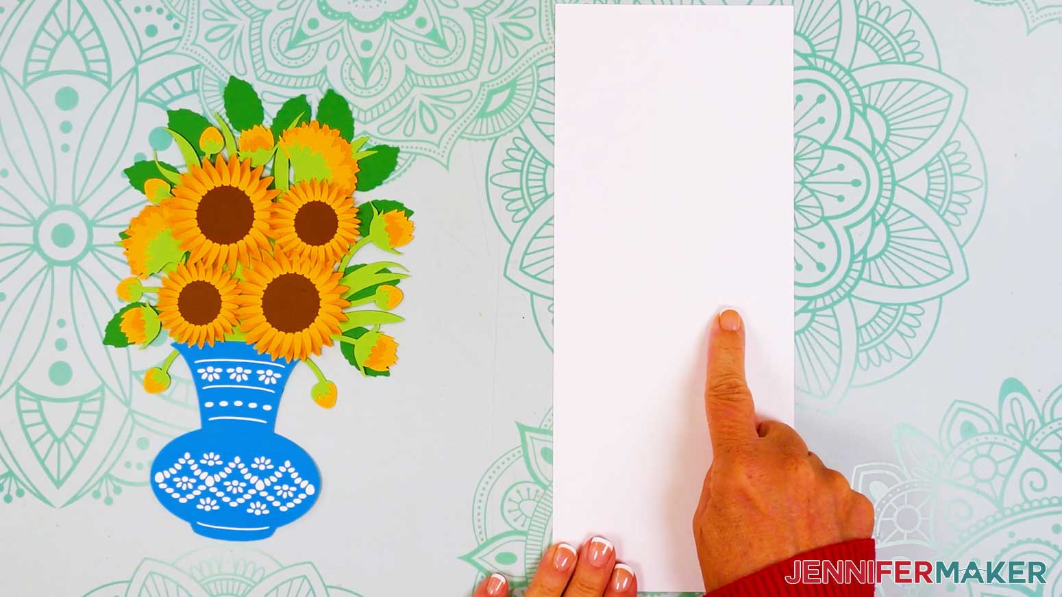The bouquet and vase have been set aside and the card base is visible with a finger pointing to the crease line of the middle of the card base.