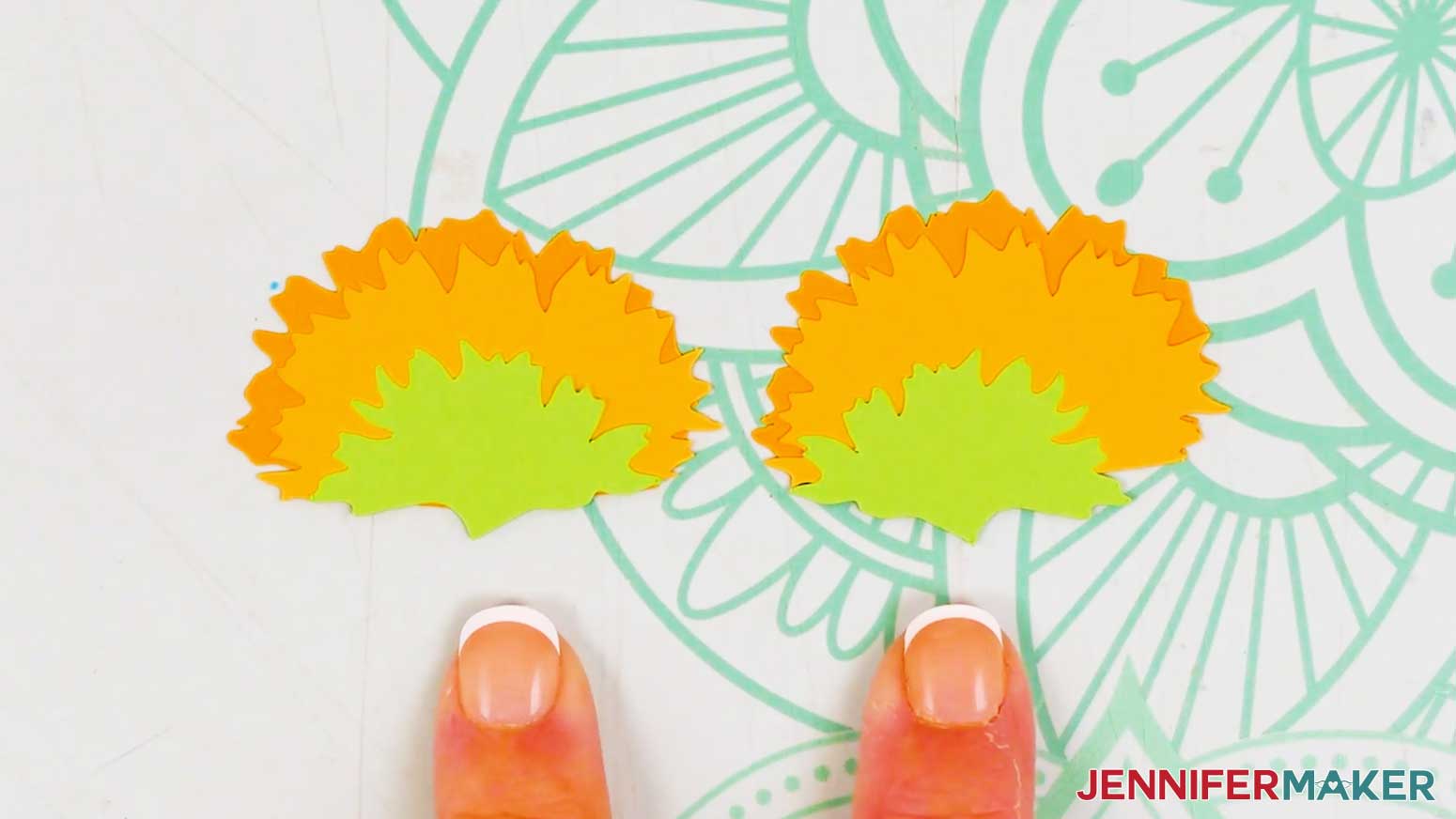 The sideways sunflowers have been stacked for glueing, the fingers point to the sepal on both flowers showing that they are mirrored versions of the same sepal.