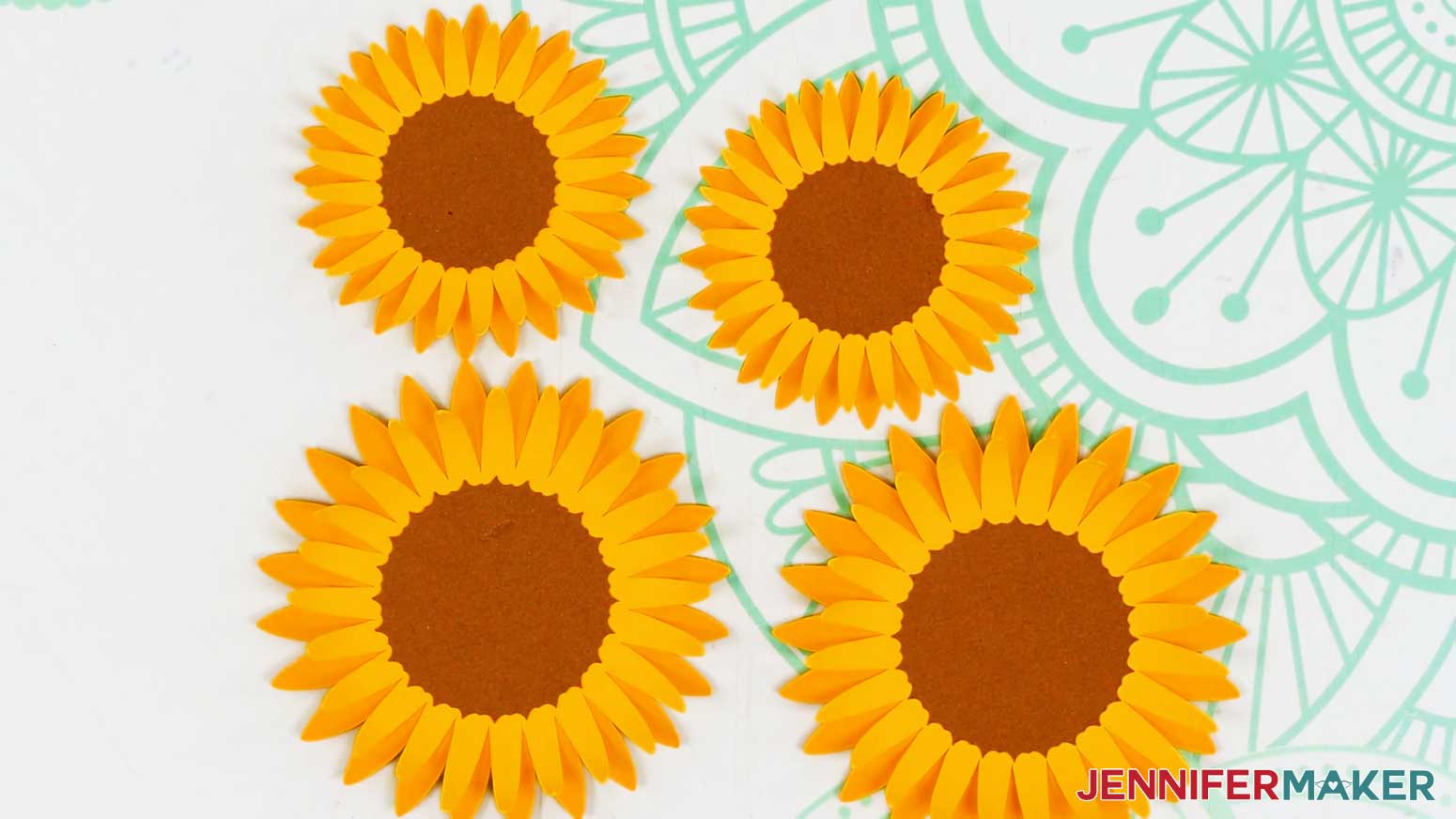 All of the sunflowers, small and large, have been assembled and lay on the table for the 3d bouquet card.