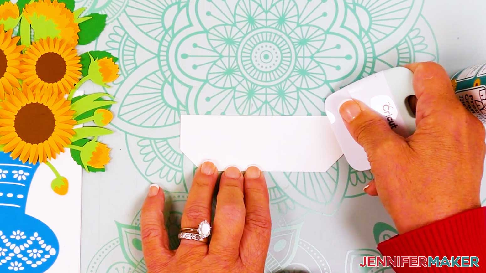 The inner card stand is shown being folded in half and using a scraper to get a crisp crease.