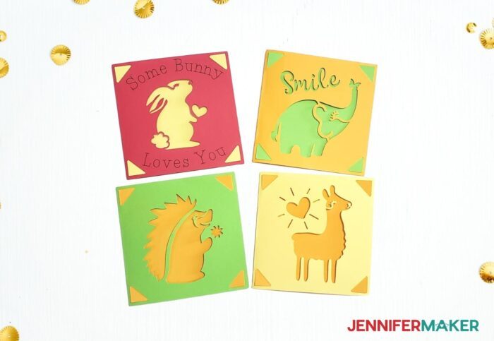 Four multicolor Cricut cards with yellow and green cutouts of cartoon animals.